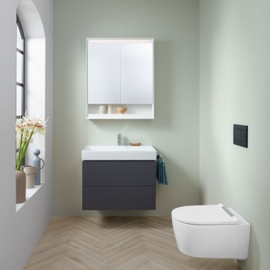 Baño pequeño en verde menta con mueble de lavabo color lava, mueble con espejo, pulsador y sanitarios Geberit