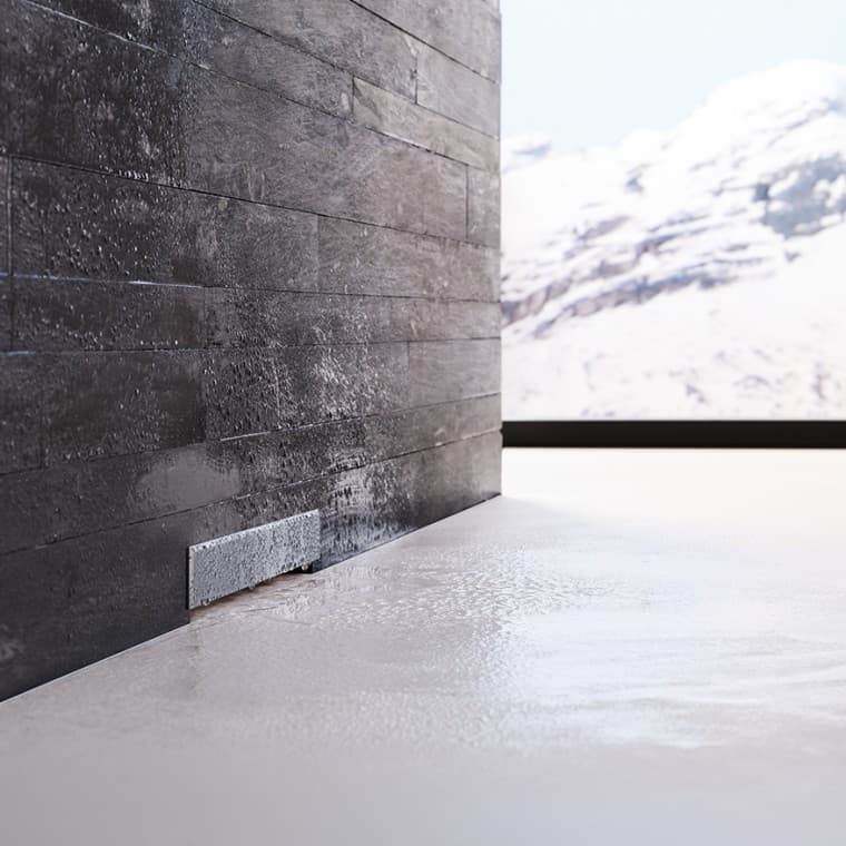 Sifón de pared Geberit en pared con revestimiento negro Sifón de pared Geberit en pared con revestimiento negro